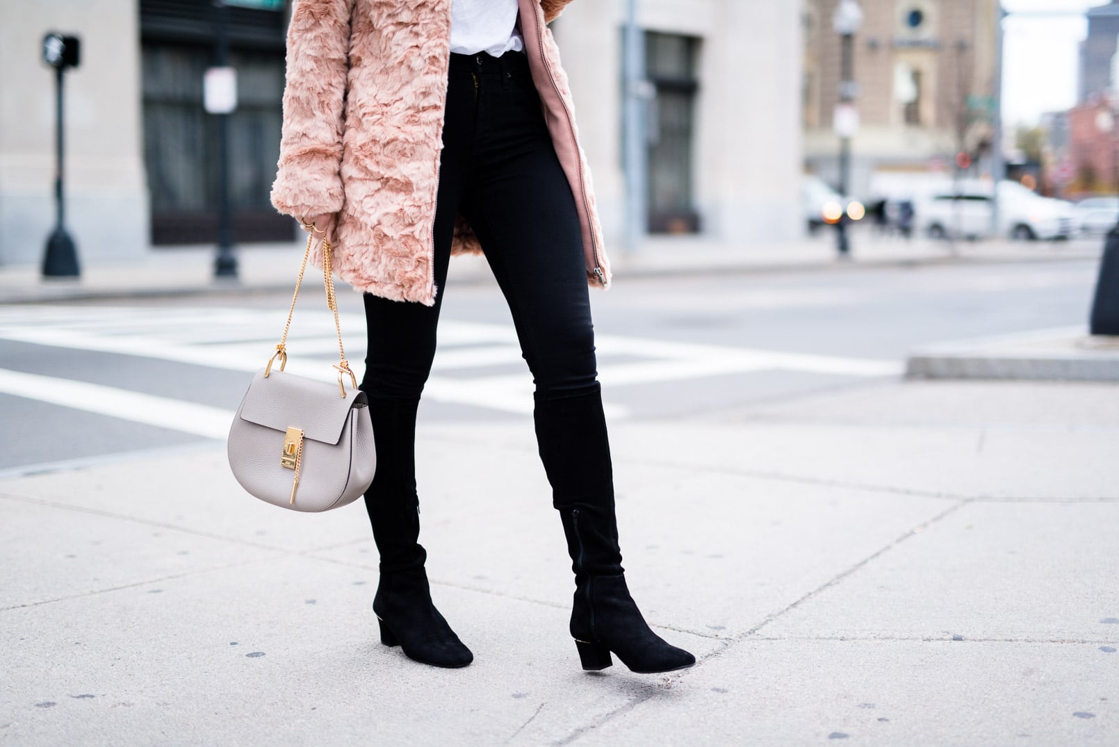 Pam Hetlinger wearing a Forever 21 Faux Fur Jacket, 7 for all Mankind black skinny jeans, delman boots, Chloé Drew Bag and Prada aviators