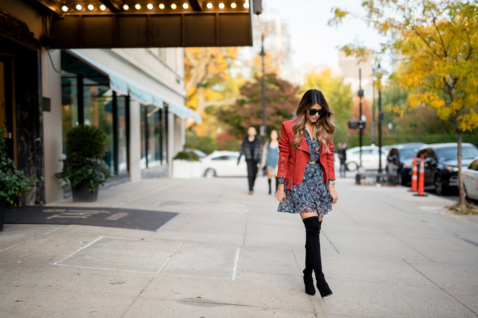 Pam Hetlinger wearing a suede fringed jacket, floral dress and Delman over-the-knee boots