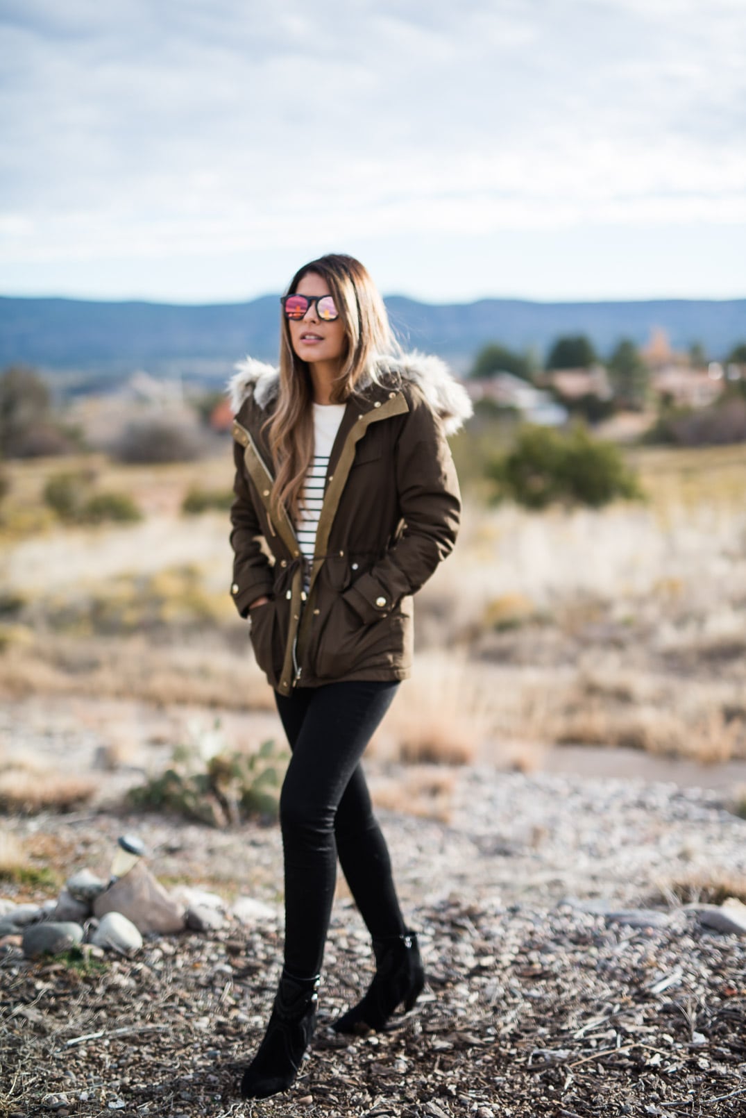 Pam Hetlinger wearing a topshop parka, h&m striped sweater, black skinny jeans and isabel marant farrah booties. Thanksgiving Outfit Idea