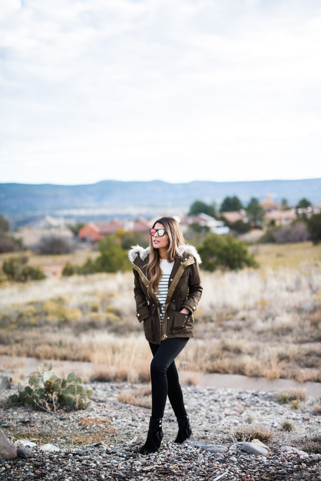 Pam Hetlinger wearing a topshop parka, h&m striped sweater, black skinny jeans and isabel marant farrah booties. Thanksgiving Outfit Idea