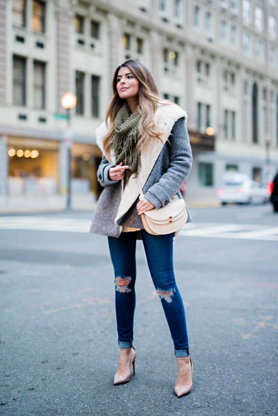 Pam Hetlinger wearing a bp fringe scarf, chloe georgia bag, asos ripped jeans, zara shearling jacket, nordstrom sweater and christian louboutin pumps. How to wear heels casually.