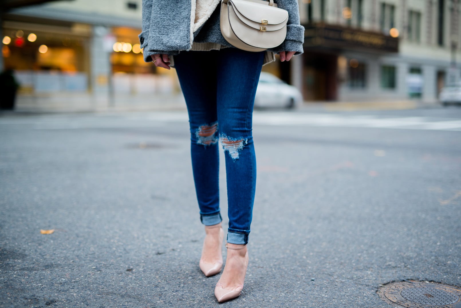 Pam Hetlinger wearing a bp fringe scarf, chloe georgia bag, asos ripped jeans, zara shearling jacket, nordstrom sweater and christian louboutin pumps. How to wear heels casually.