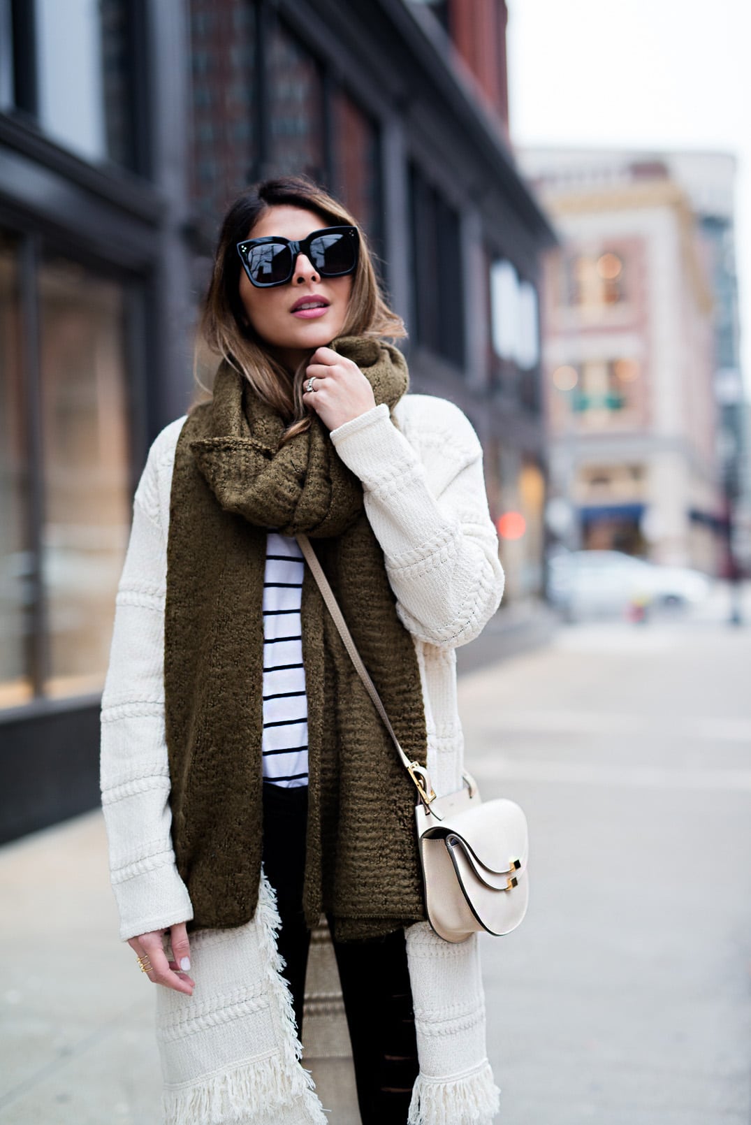 Pam Hetlinger wearing a Mango Striped Tee, Mango Black Booties, DSTLD Black Ripped Jeans, Mango Fringe Cardigan and a Forever 21 Khaki Scarf