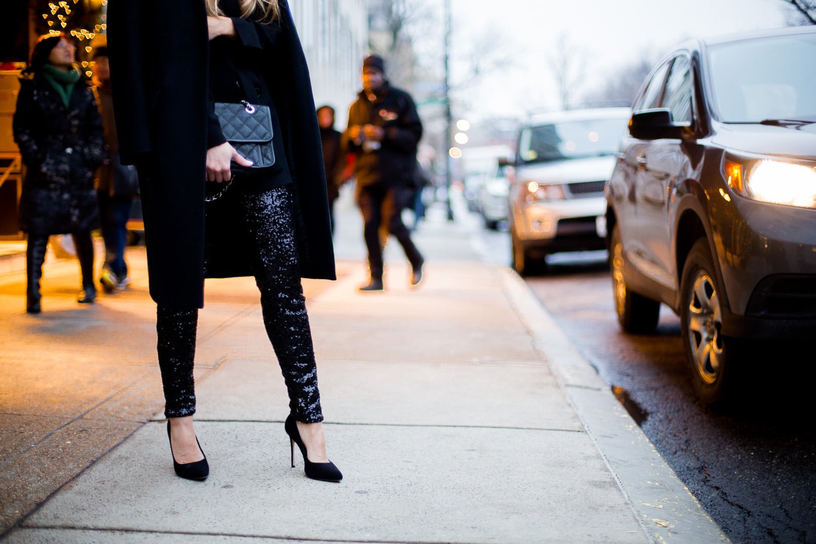 Pam Hetlinger The Girl From Panama wearing H&M sequined pants, zara black belted blazer, black pumps, black wool coat and a chanel bag french riviera flap. holiday look, new years eve look.