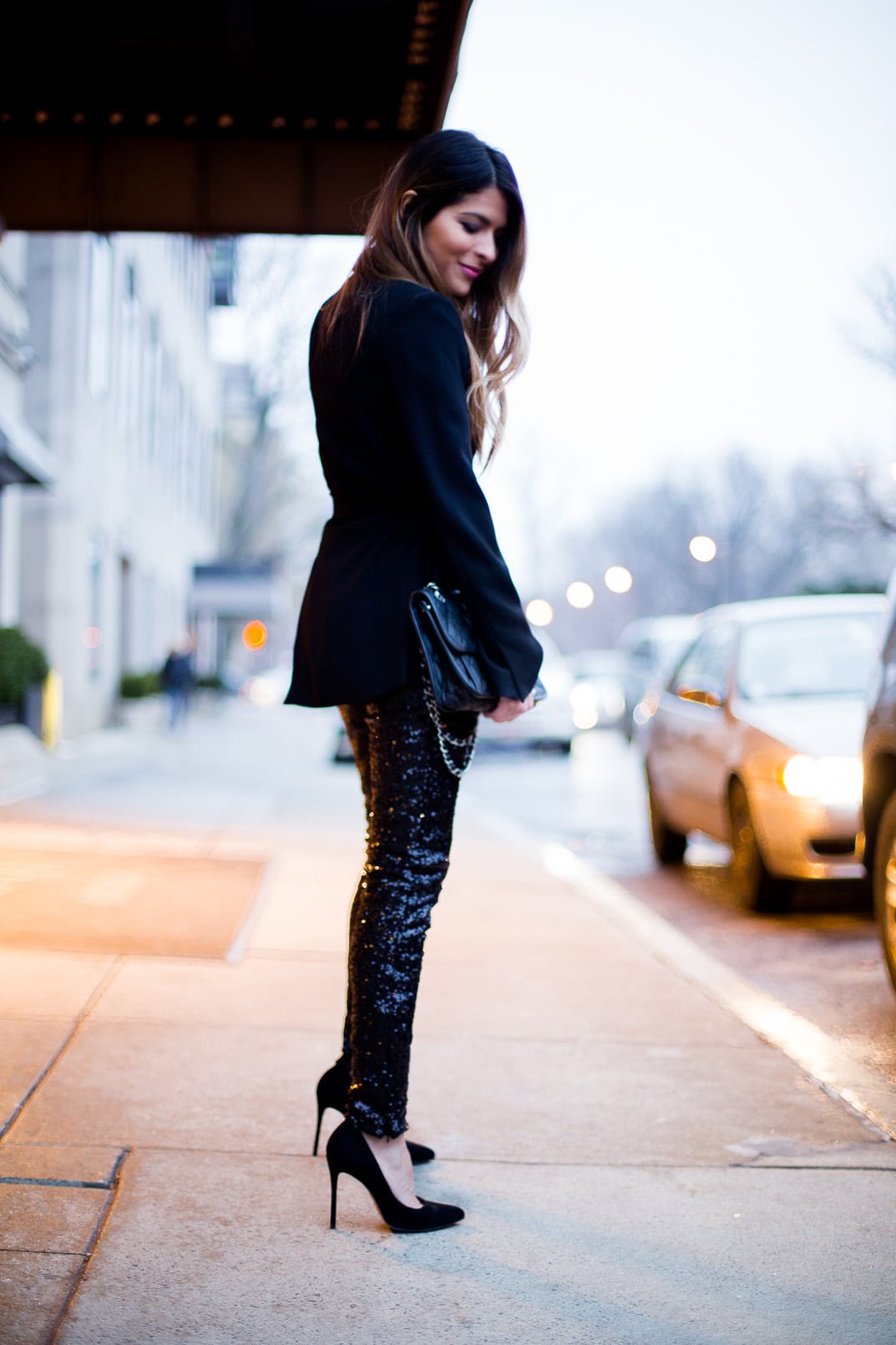 Pam Hetlinger The Girl From Panama wearing H&M sequined pants, zara black belted blazer, black pumps, black wool coat and a chanel bag french riviera flap. holiday look, new years eve look.