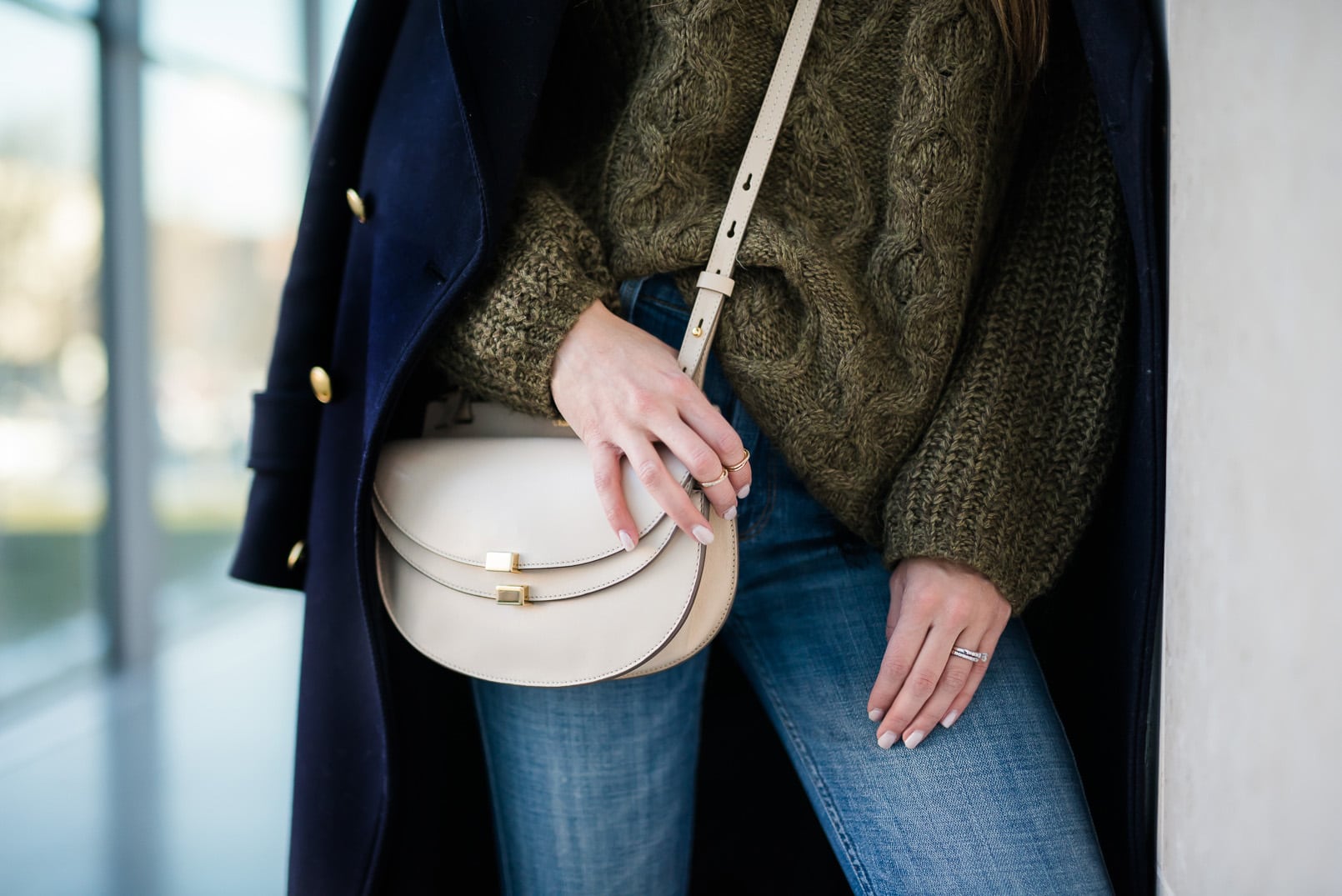 Pam Hetlinger, The Girl From Panama wearing a Khaki sweater, h&m navy coat, 7 for all mankind ginger jeans, gray booties, and chloe georgia bag.