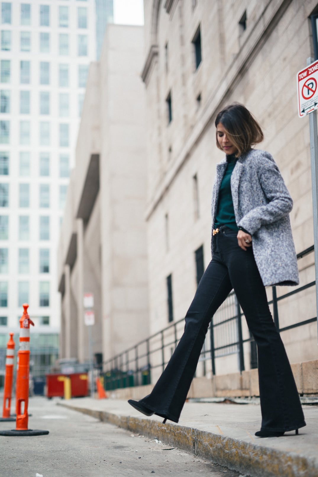 Pam Hetlinger, The Girl From Panama wearing a Topshop Funnel Neck Long Sleeve Top, Mango Flare Jeans, and Gray Coat.