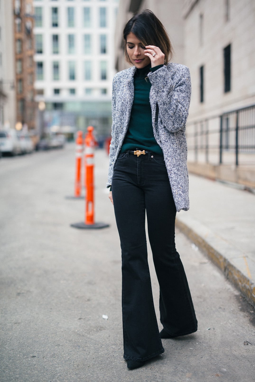 Pam Hetlinger, The Girl From Panama wearing a Topshop Funnel Neck Long Sleeve Top, Mango Flare Jeans, and Gray Coat.