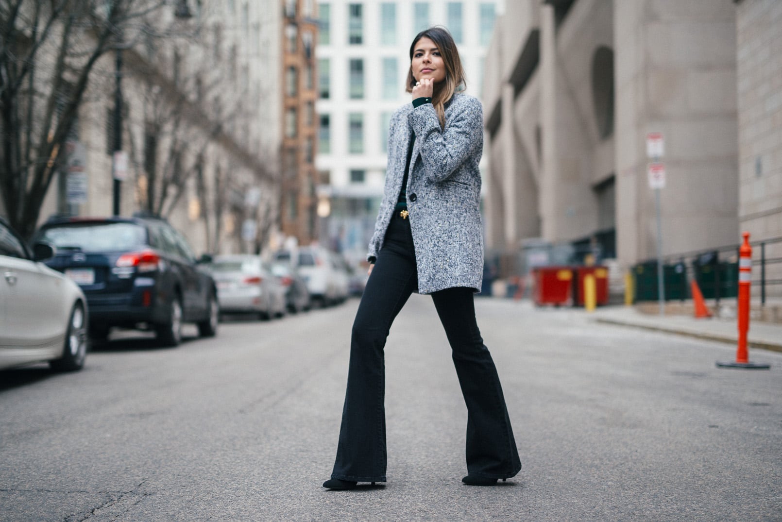 Pam Hetlinger, The Girl From Panama wearing a Topshop Funnel Neck Long Sleeve Top, Mango Flare Jeans, and Gray Coat.