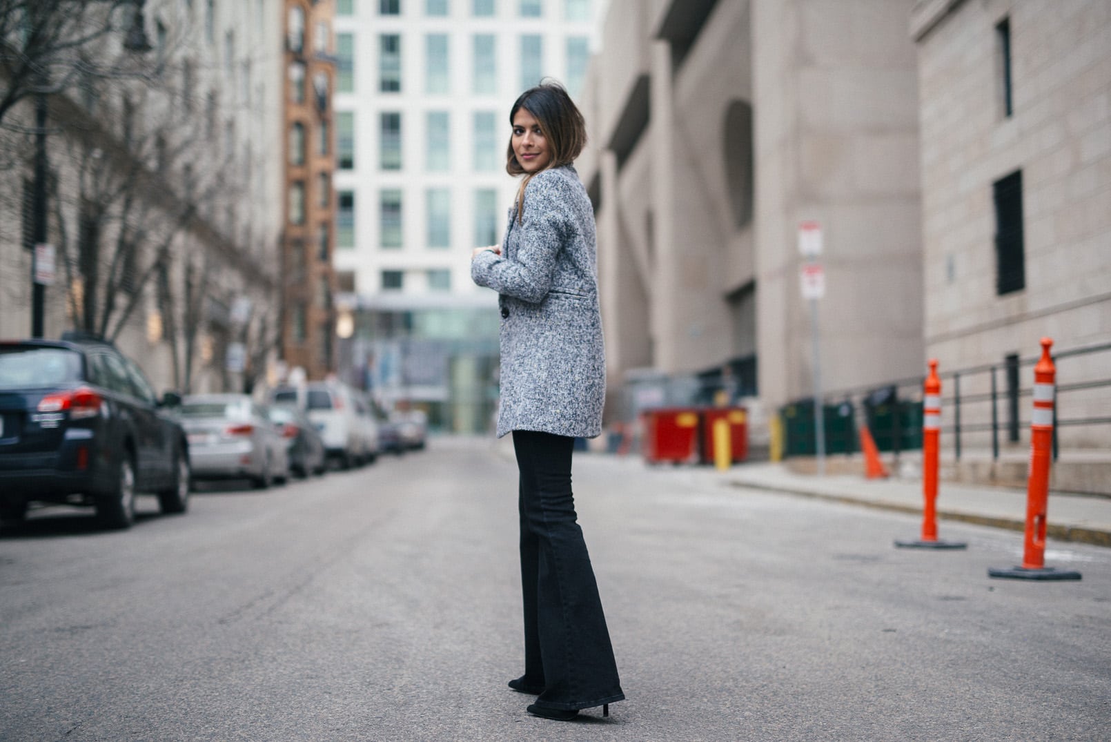 Pam Hetlinger, The Girl From Panama wearing a Topshop Funnel Neck Long Sleeve Top, Mango Flare Jeans, and Gray Coat.