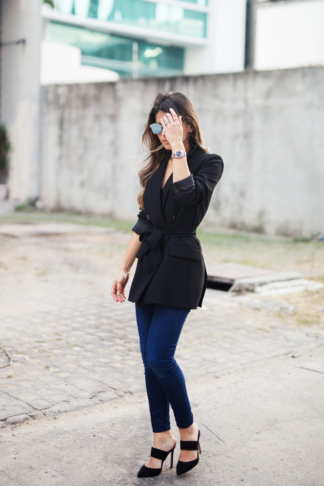 Pam Hetlinger, The Girl From Panama wearing a Zara Belted Blazer, Joe's Jeans, whistles pointed toe slide mules, and Dior Abstract Sunglasses.