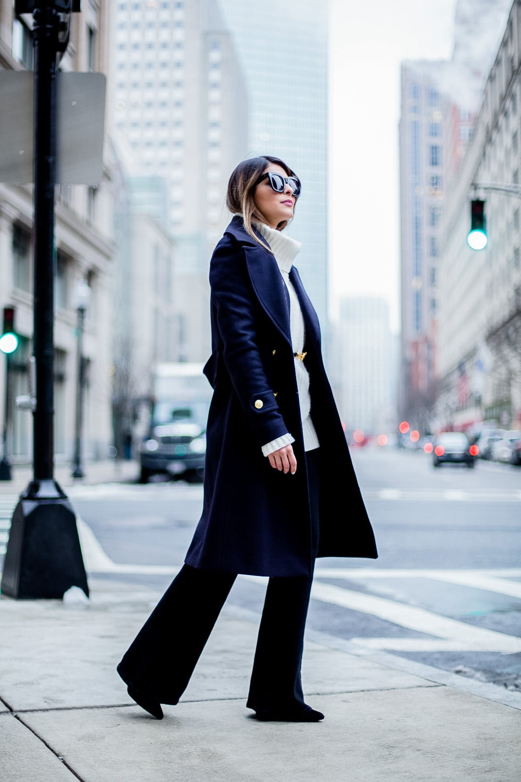 Pam Hetlinger, The Girl From Panama wearing an h&m navy coat, celine sunglasses, thin belt, mango flare jeans, white turtleneck sweater and chloe georgia bag.