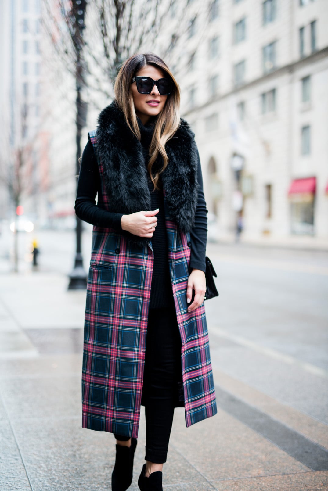 Pam Hetlinger wearing the fifth label tartan plaid vest, ann taylor faux fur stole, black turtleneck sweater, black skinny jeans, and zara black booties