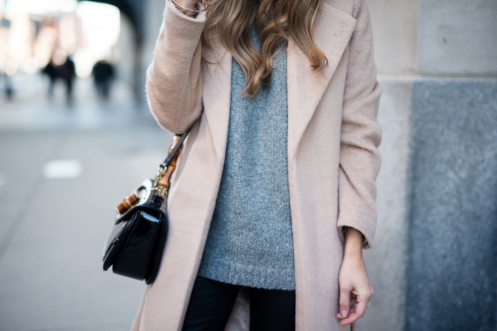 Pam Hetlinger wearing a Camel Coat, Gray Sweater, Leather Leggins, Over the Knee Boots, Winter Outfit Inspiration.