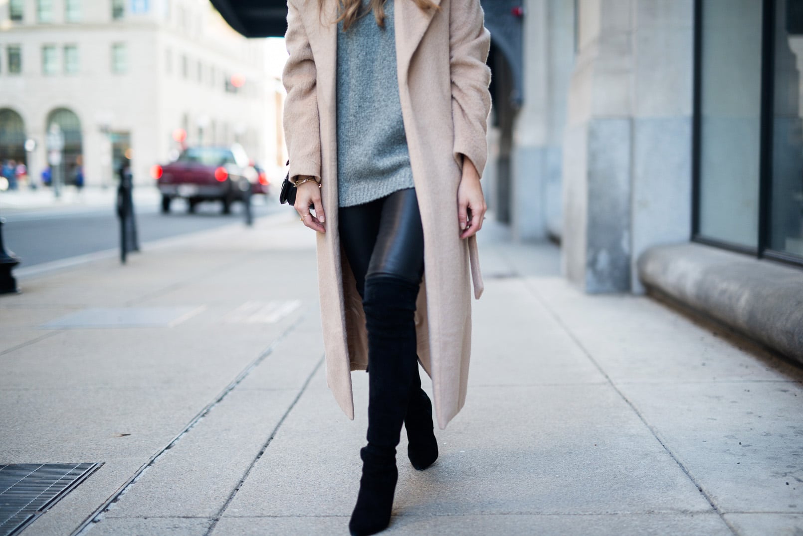 Pam Hetlinger wearing a Camel Coat, Gray Sweater, Leather Leggins, Over the Knee Boots, Winter Outfit Inspiration.