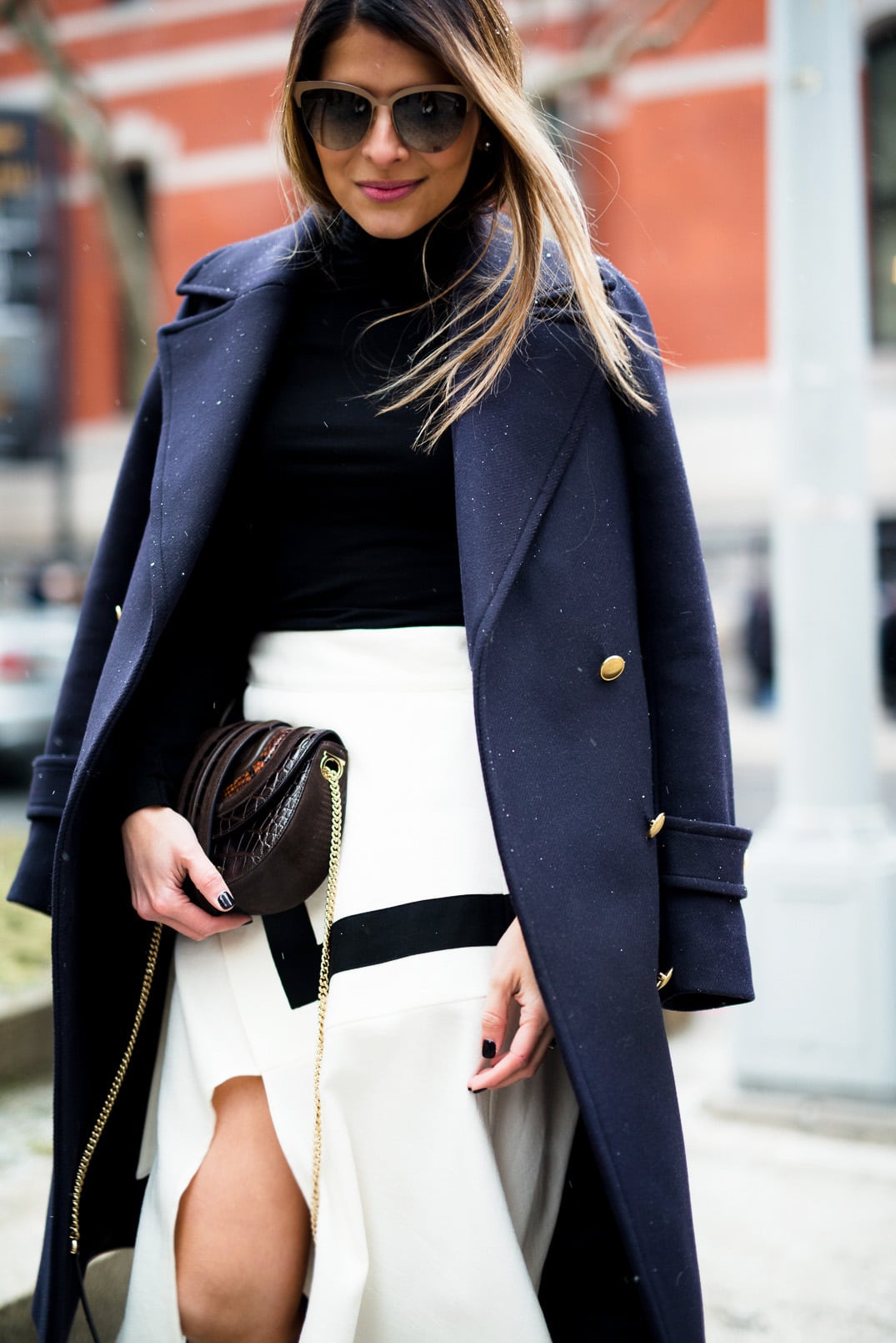 Pam Hetlinger, The Girl From Panama wearing a H&M navy coat, black turtleneck, finders keepers label lay it down skirt, barbara bui brown knee high boots, and salvatore ferragamo bag during New York Fashion Week.