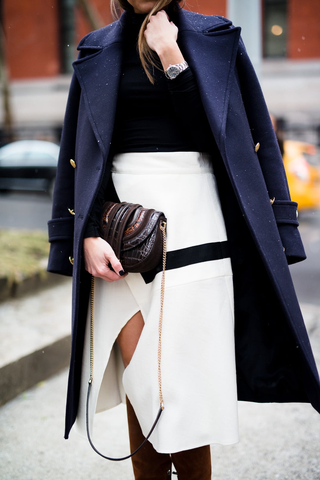 Pam Hetlinger, The Girl From Panama wearing a H&M navy coat, black turtleneck, finders keepers label lay it down skirt, barbara bui brown knee high boots, and salvatore ferragamo bag during New York Fashion Week.