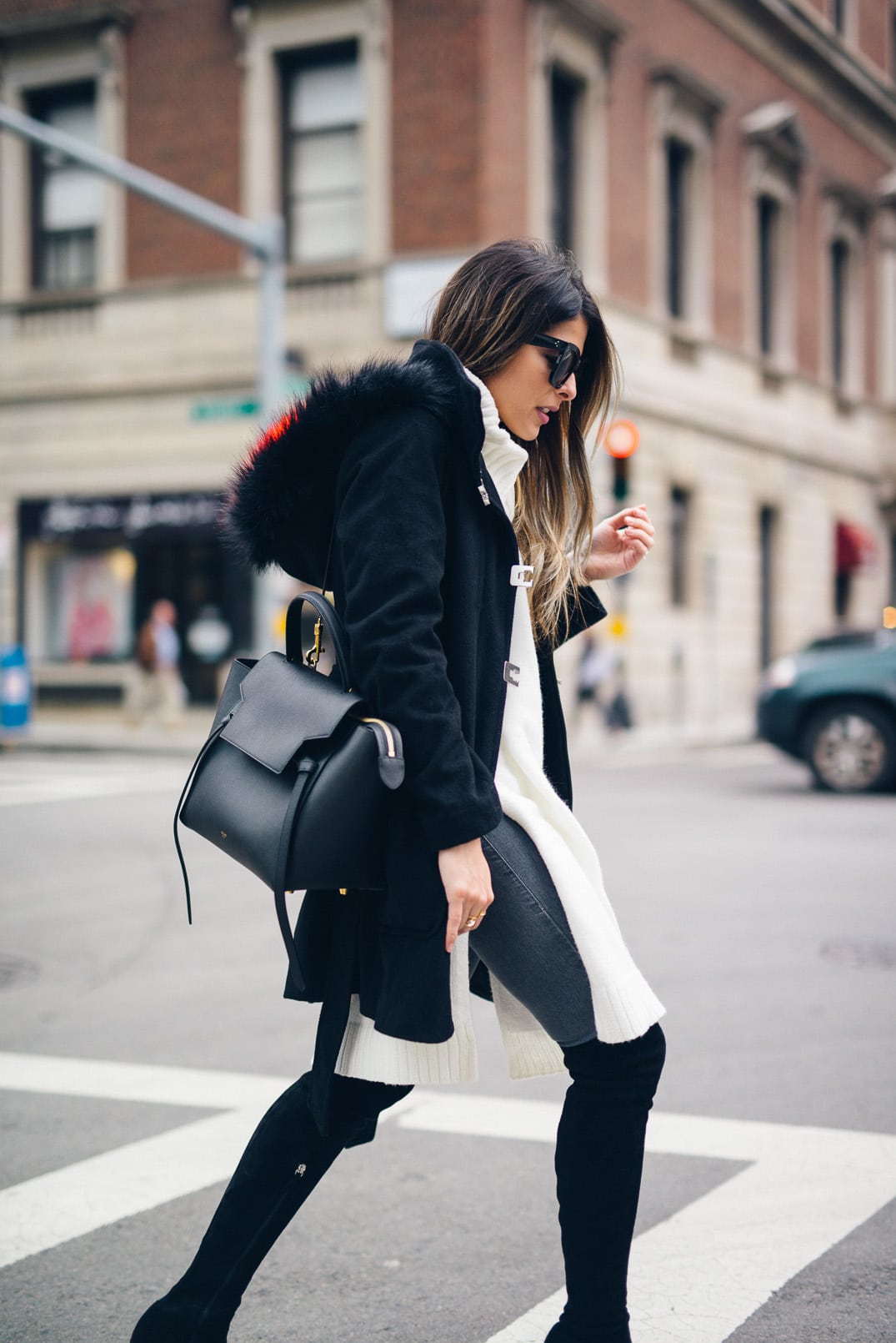 Pam Hetlinger, The Girl From Panama wearing Over-the-knee-boots, sleeveless tunic, gray denim, black coat, celine belt bag, and celine sunglasses