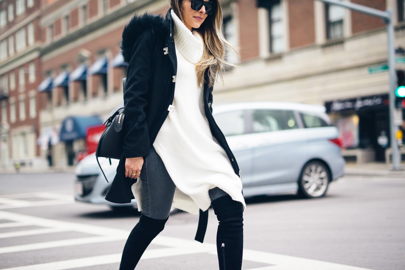 Pam Hetlinger, The Girl From Panama wearing Over-the-knee-boots, sleeveless tunic, gray denim, black coat, celine belt bag, and celine sunglasses