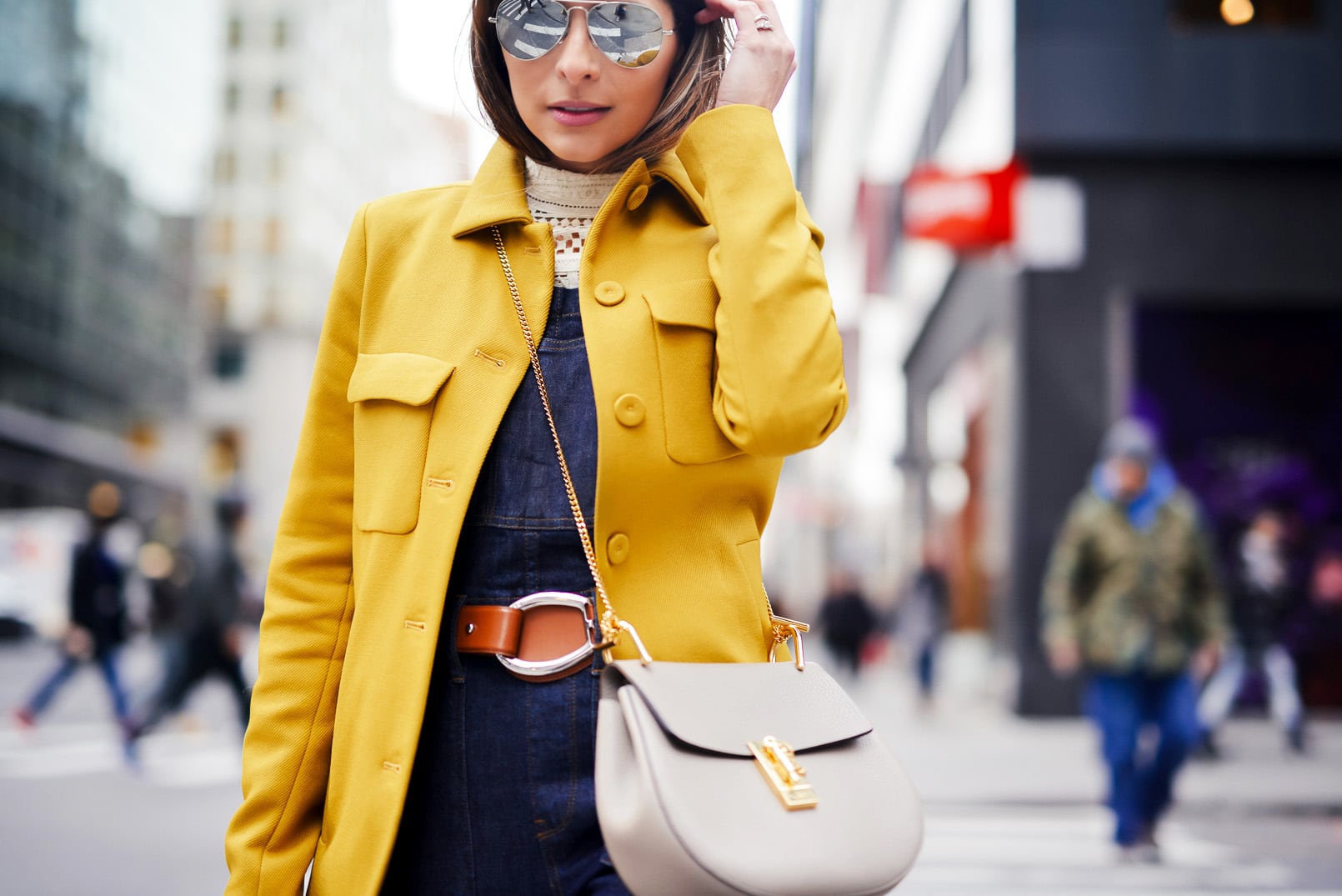 Pam Hetlinger, The Girl From Panama wearing Madewell Overalls, Zara Yellow Coat, Balenciaga Buckle Booties, Chloe Drew Bag in Grey, Crochet Top, New York Fashion Week