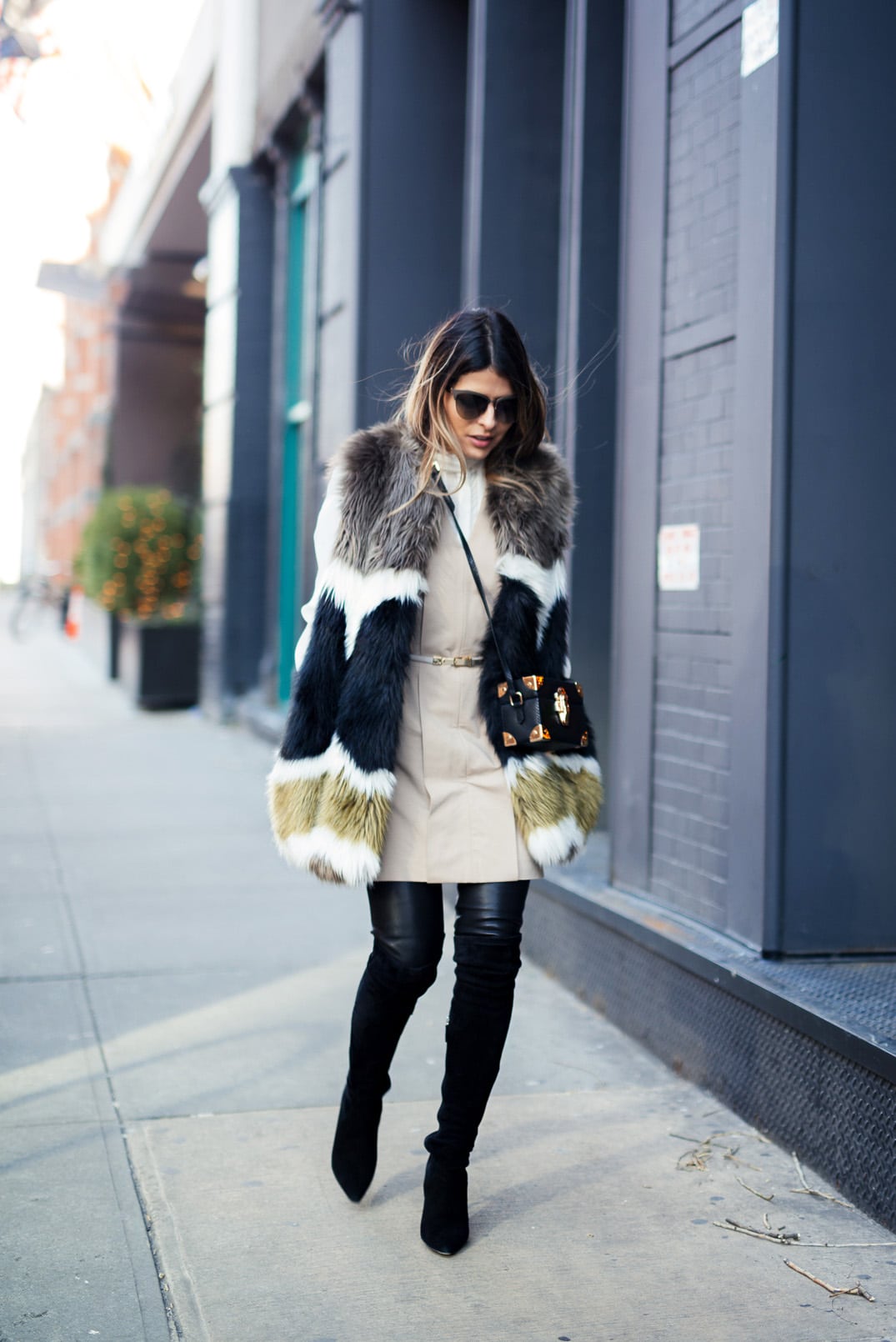 Pam Hetlinger wearing a dawn levy fur coat, black over the knee boots, and khaki shift dress. new york fashion week.