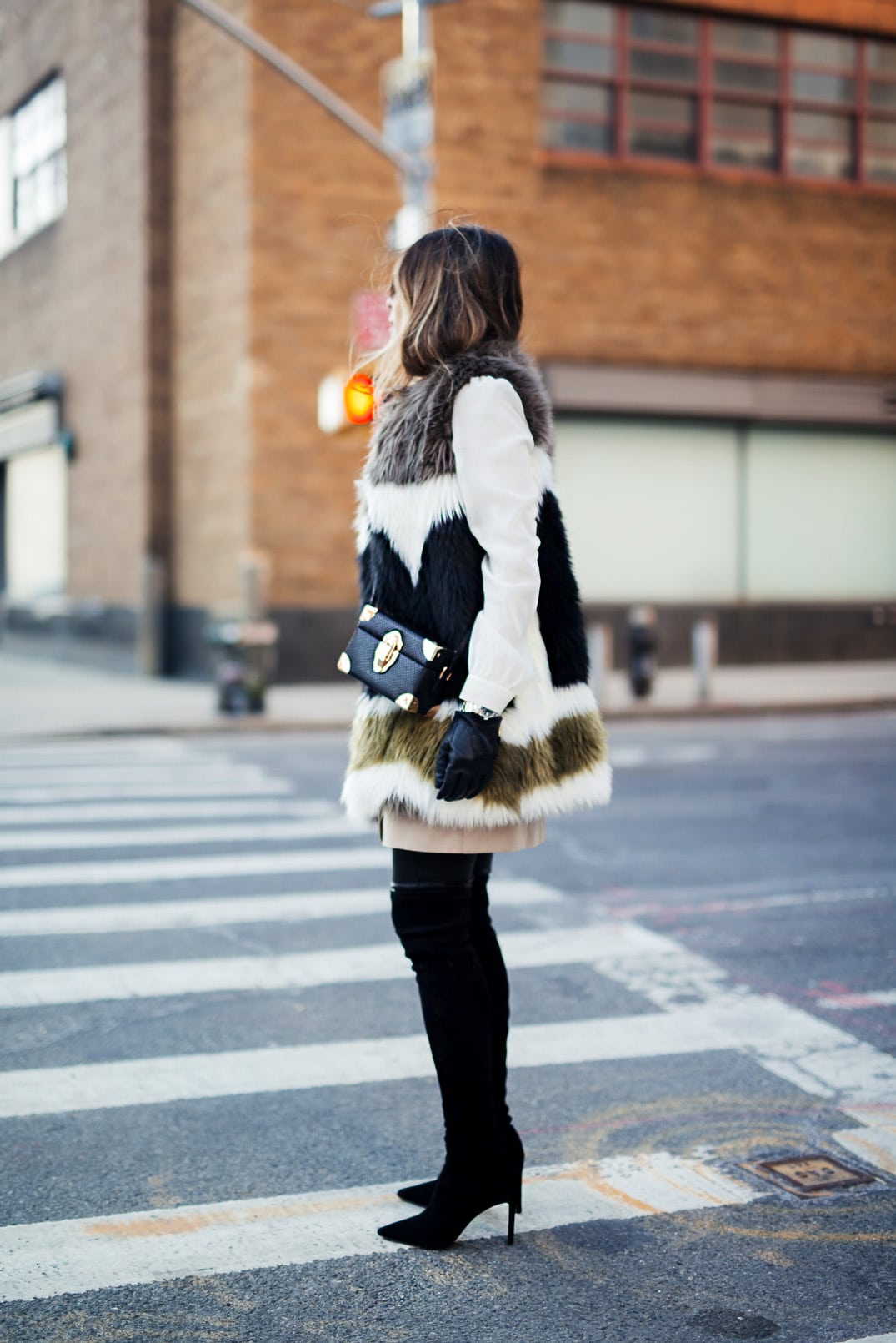 Pam Hetlinger wearing a dawn levy fur coat, black over the knee boots, and khaki shift dress. new york fashion week.