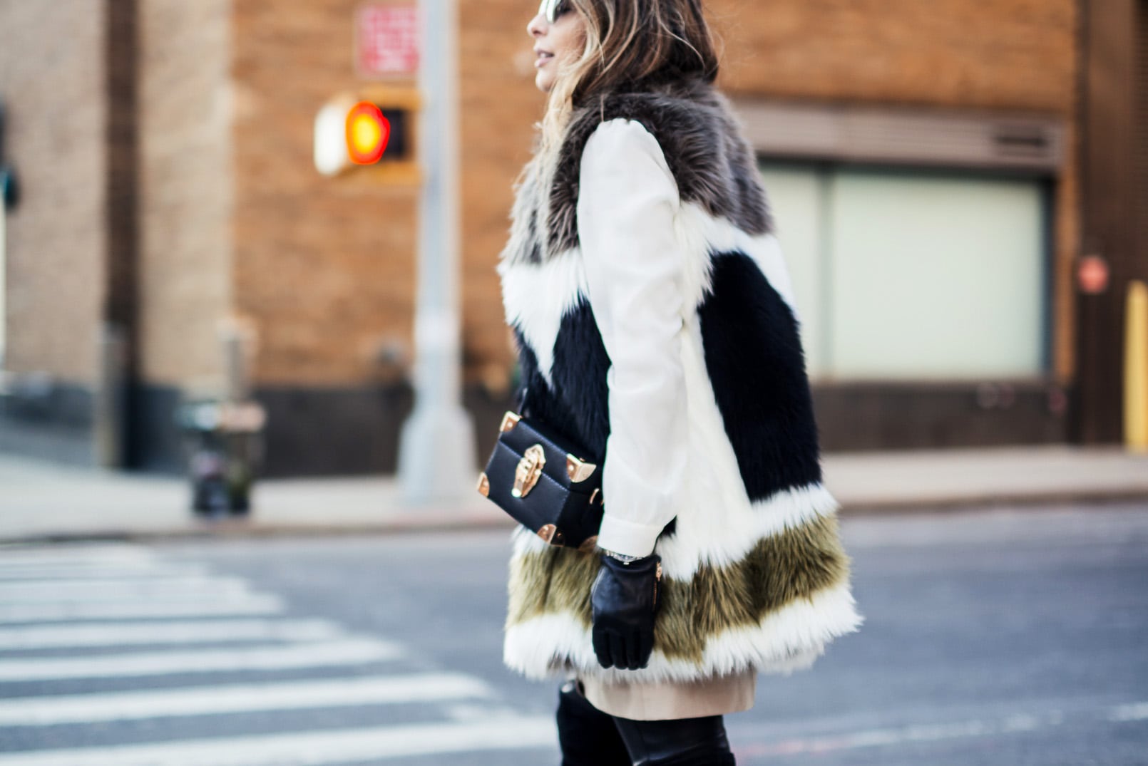 Pam Hetlinger wearing a dawn levy fur coat, black over the knee boots, and khaki shift dress. new york fashion week.