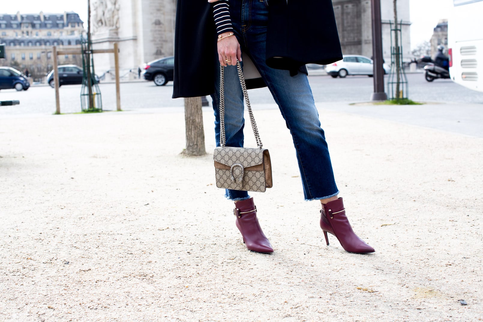 Pam Hetlinger wearing a Kate Spade Jenji Capelet, striped turtleneck, 7 for all Mankind skinny cropped jeans, Gucci Dionysus GG Supreme shoulder bag and balenciage buckle booties. Paris Fashion Week.