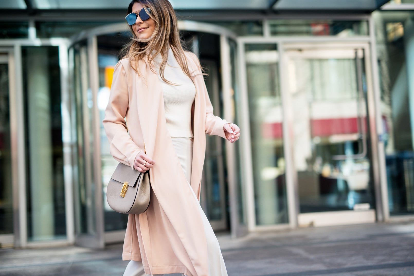 Pam Hetlinger wearing a Mango blush jacket, reiss lace up pumps, h&m high waisted white pants, h&m white crop top sweater, dior sunglasses, and chloe drew bag.