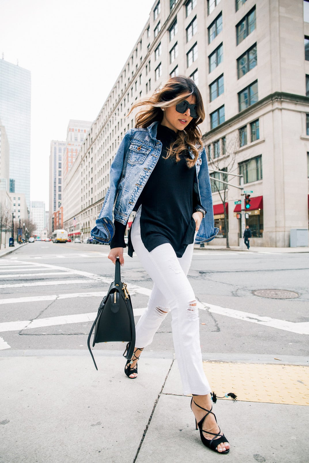 Pam Hetlinger wearing a denim jacket, Aquazzura Poppy Delevingne Hero lace-up suede and leather sandals, cropped white skinny jeans, asos black sweater, and celine belt bag