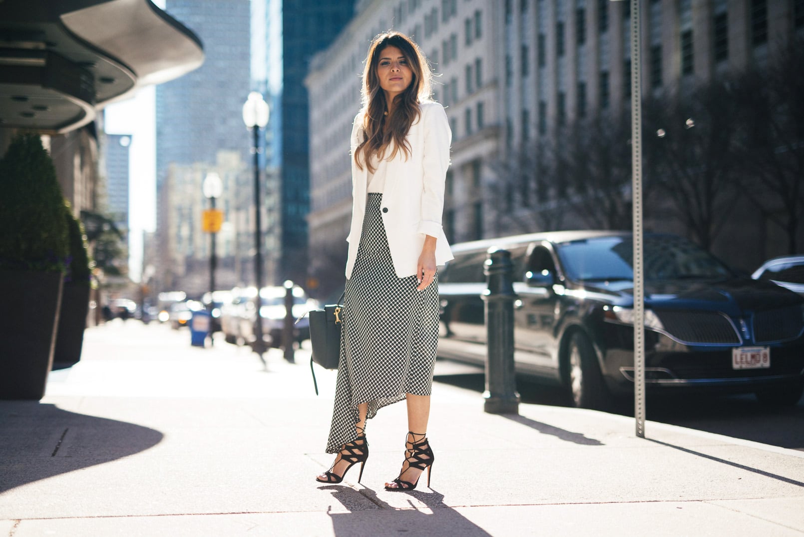 Pam Hetlinger, The Girl From Panama wearing Aquazzura Beverly Hills Sandals, C-MEO all lights skirt, Express Barcelona Cami, Club Monaco White Blazer, Celine Belt Bag, Lace Bralette