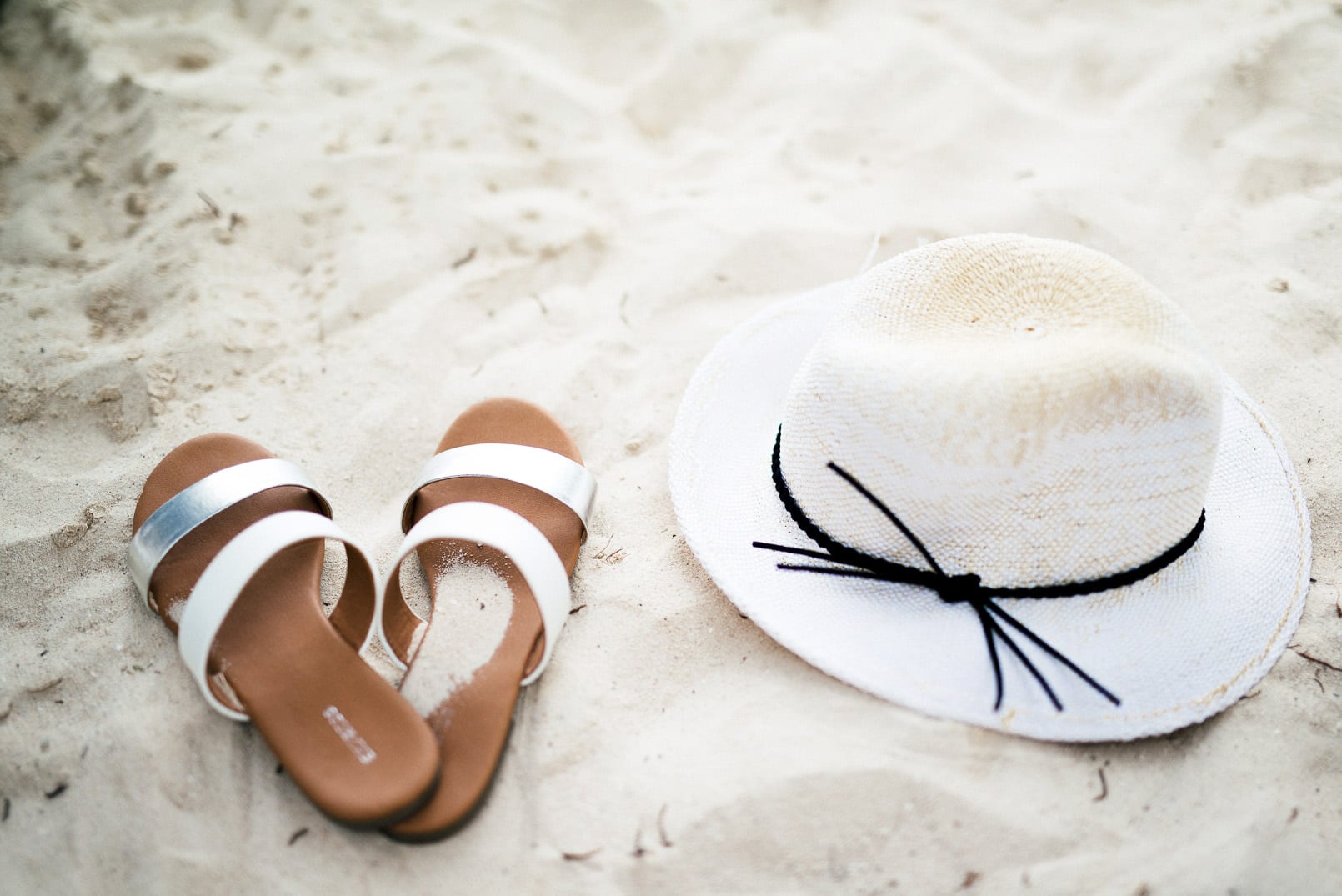 Pam Hetlinger, The Girl From Panama wearing an express black deep v high cut one-piece swimsuit, express mixed black and white print cover-up, two strap slide sandals and a Panama Hat.