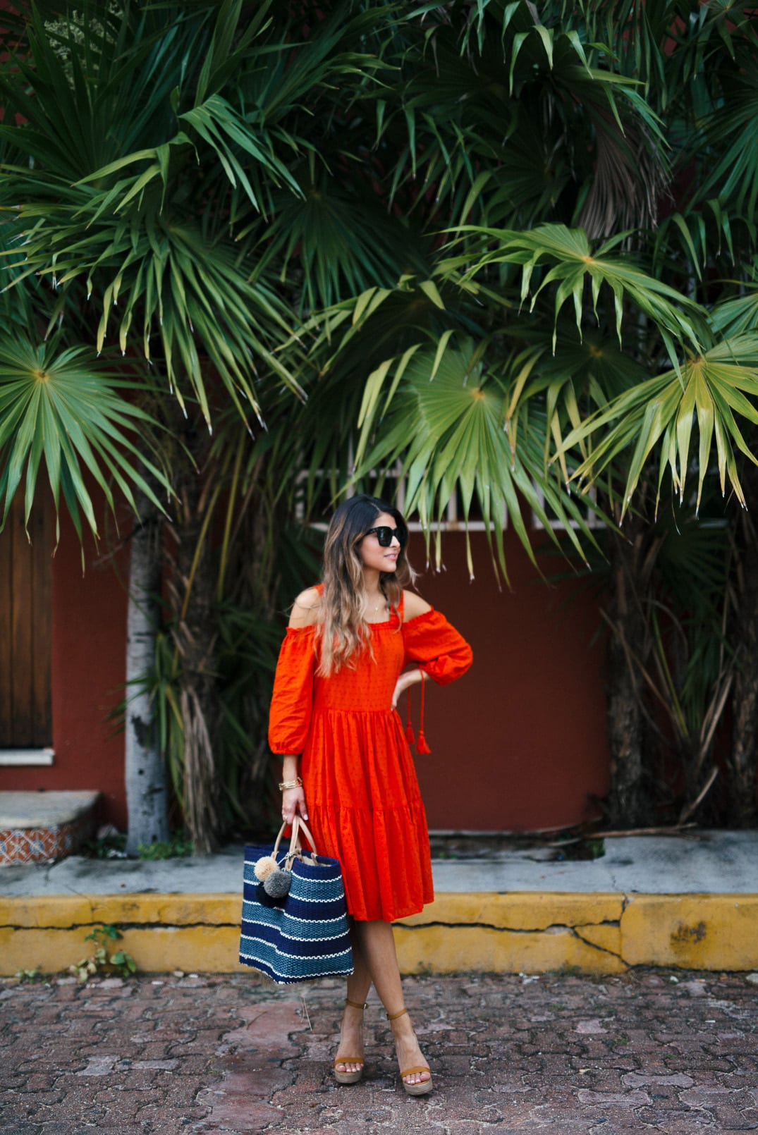 Pam Hetlinger wearing a m.gemi albero sandals, h&m red dress, celine sunglasses, and a mar y sol capri tote.