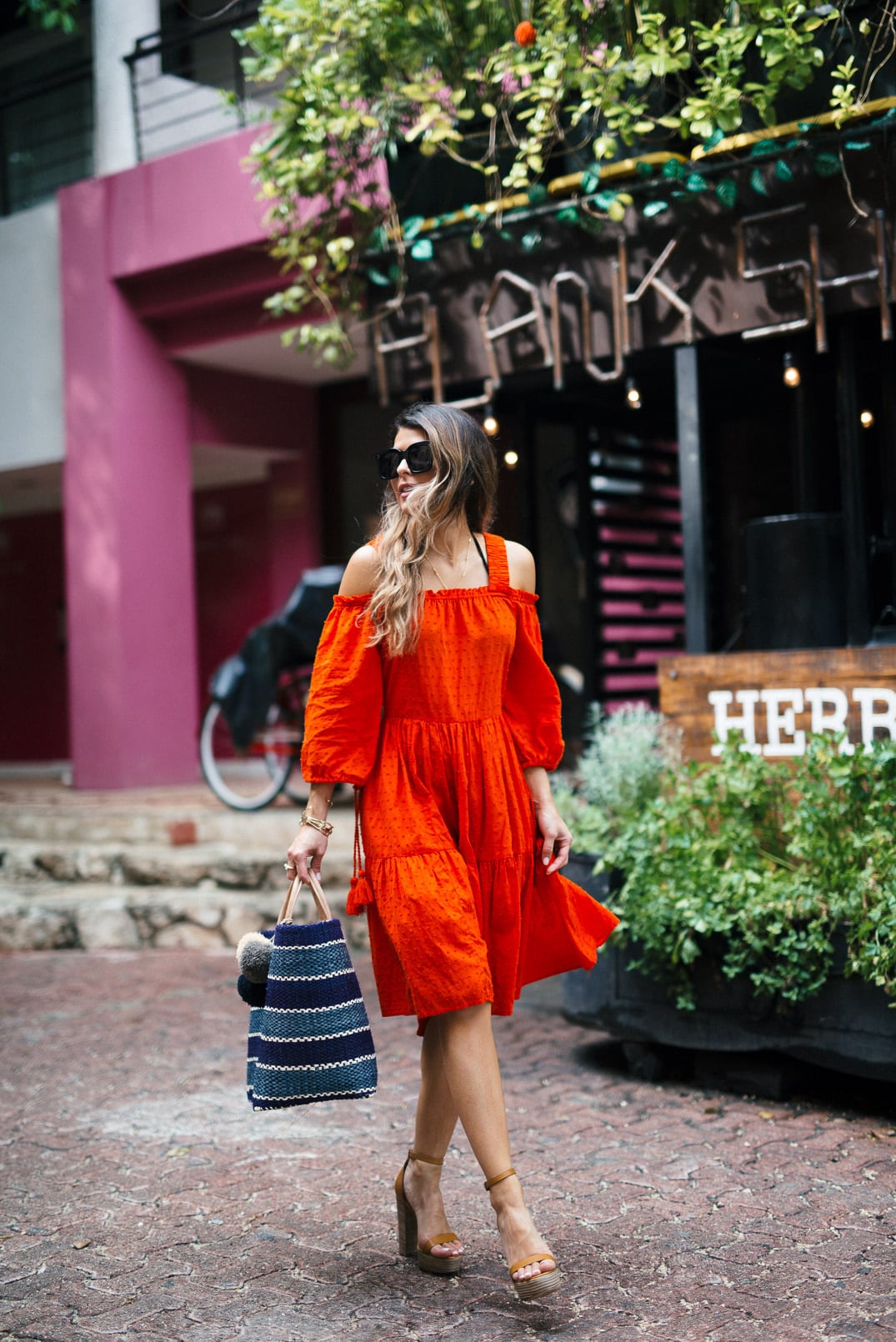 Pam Hetlinger wearing a m.gemi albero sandals, h&m red dress, celine sunglasses, and a mar y sol capri tote.