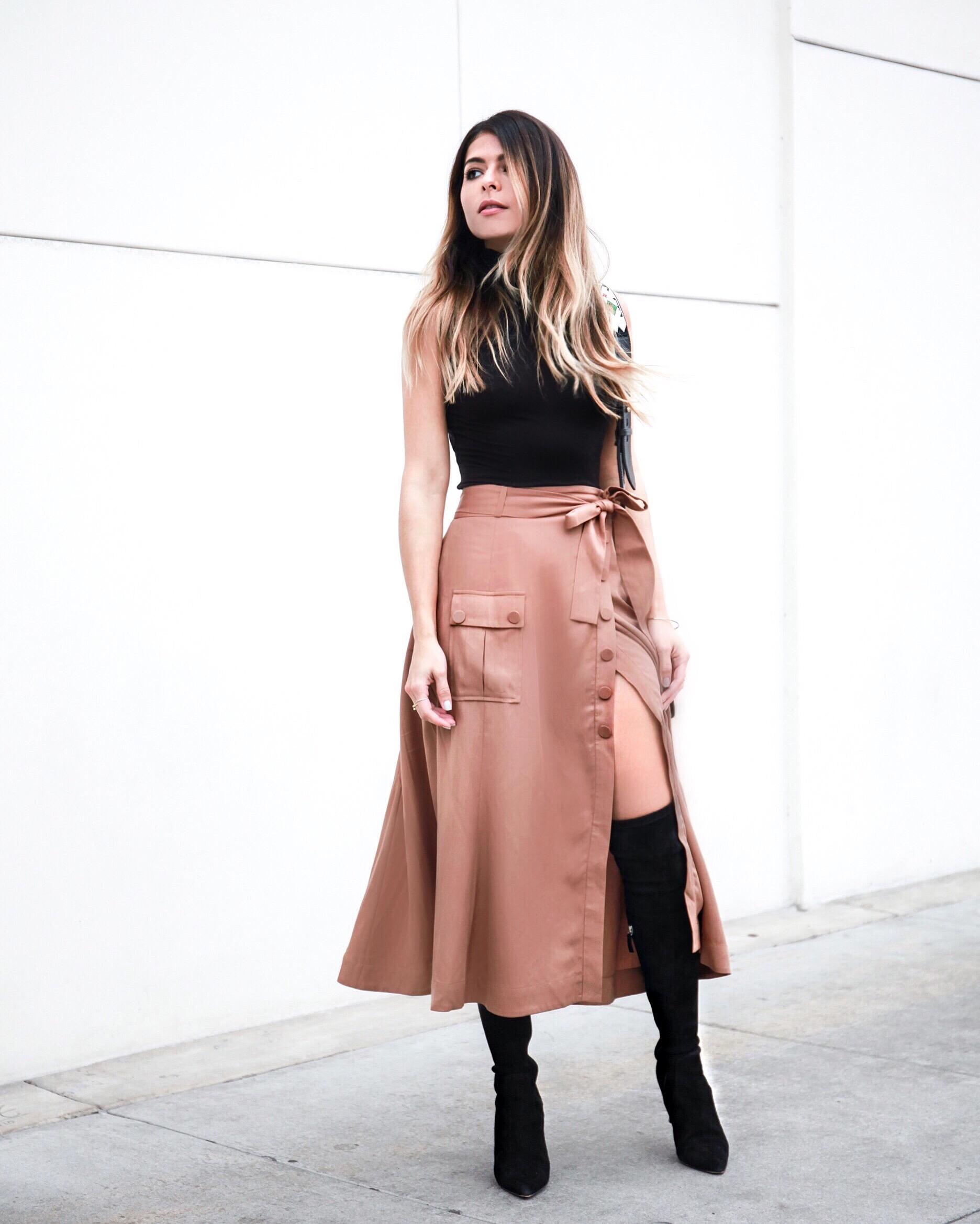  Over-the-knee boots, high slit skirt, sleeveless turtleneck. The Girl From Panama.