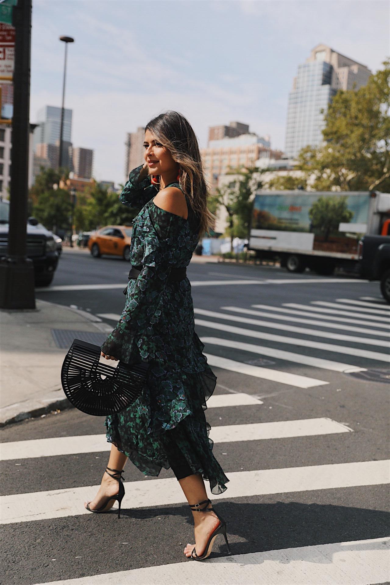 Pam Hetlinger wearing a Tanya Taylor dress with a cult gaia bag and high heels during NYFW