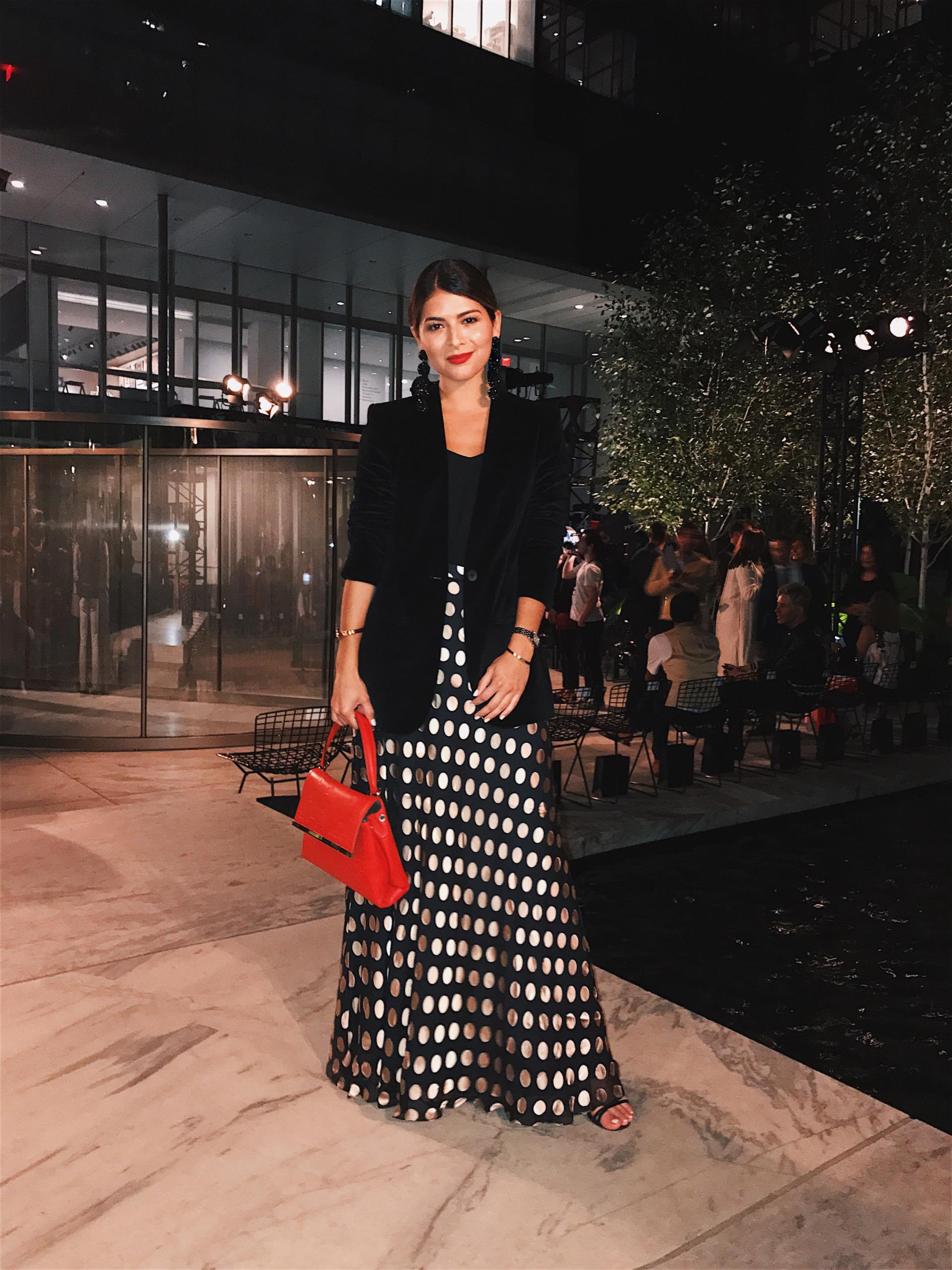 Pam Hetlinger at the Carolina Herrera Spring 2018 Show wearing a skirt by Zimmermann and a velvet jacket by Madewell