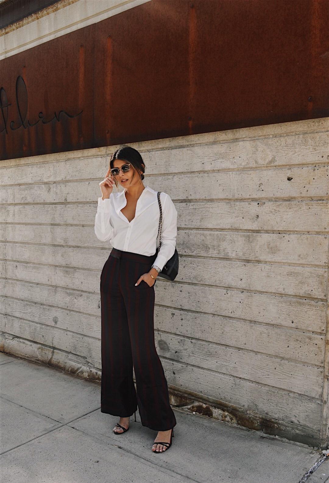 Pam Hetlinger wearing striped pants and a white shirt during NYFW