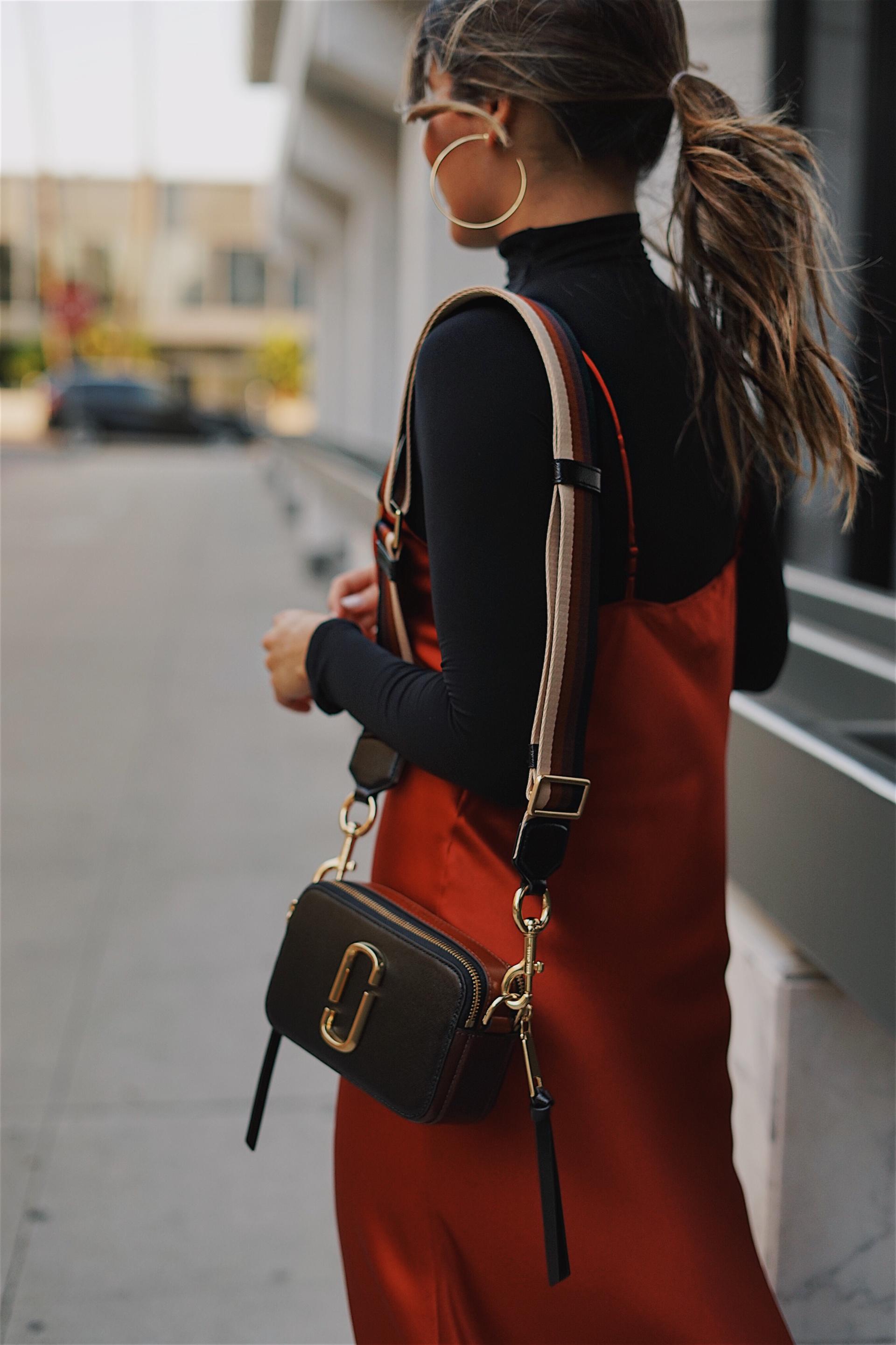 Pam Hetlinger wearing a marc jacobs camera bag and a red silk dress