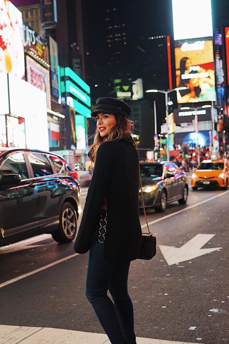 Pam Hetlinger wearing Rachel Zoe ringed turtleneck and a baker boy cap in Times Square NYC.
