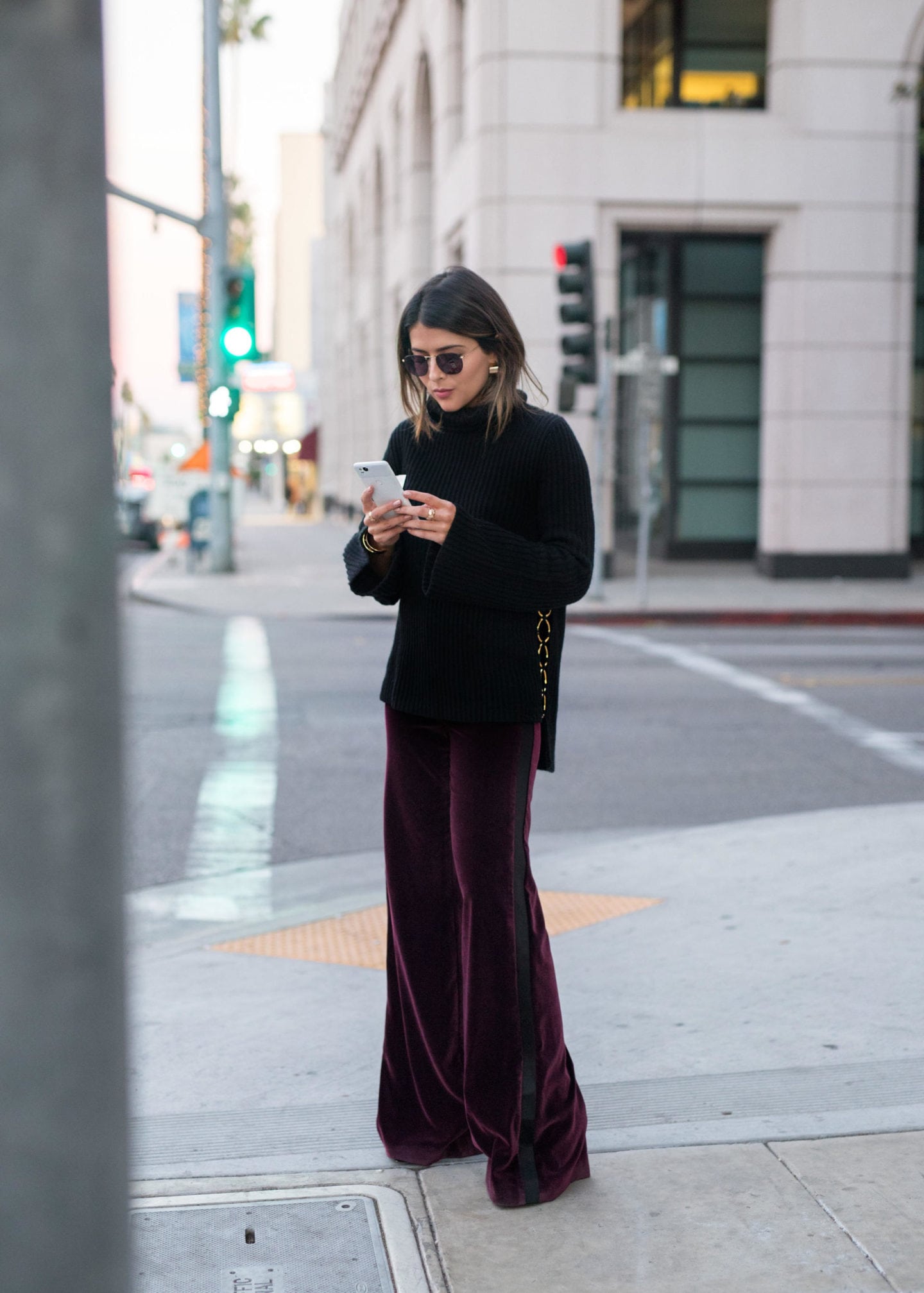Pam Hetlinger of the fashion, beauty, lifestyle, and travel blog, The Girl From Panama, styles velvet pants and a turtleneck sweater