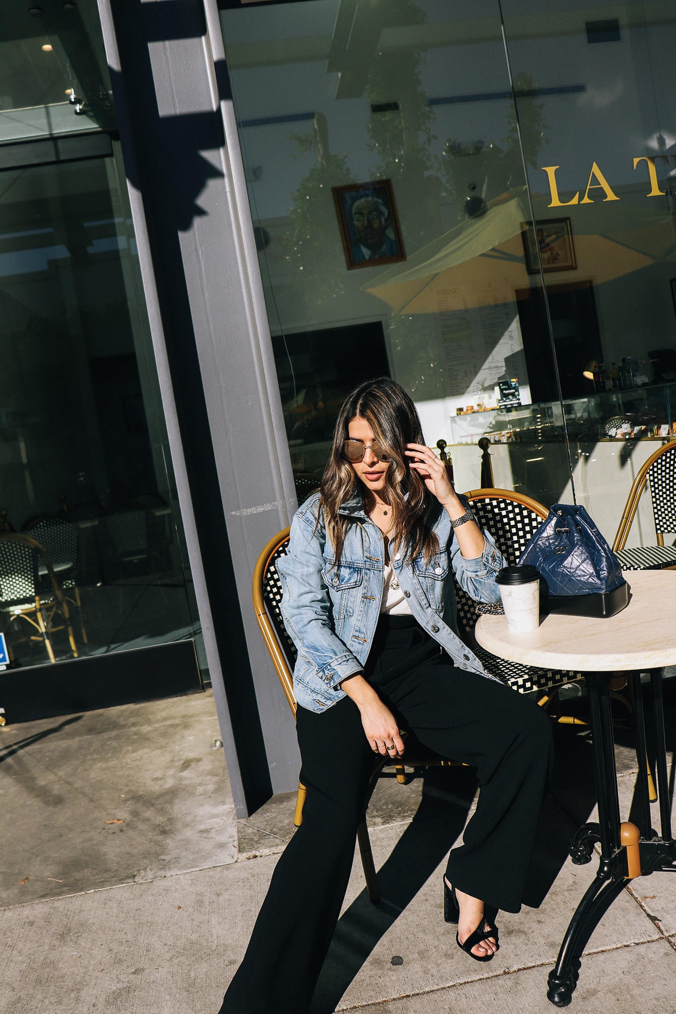 Denim Jacket with layered necklaces and round sunglasses