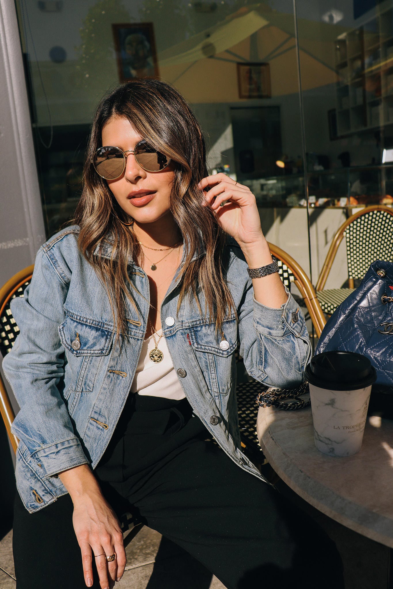 Denim Jacket with layered necklaces and round sunglasses
