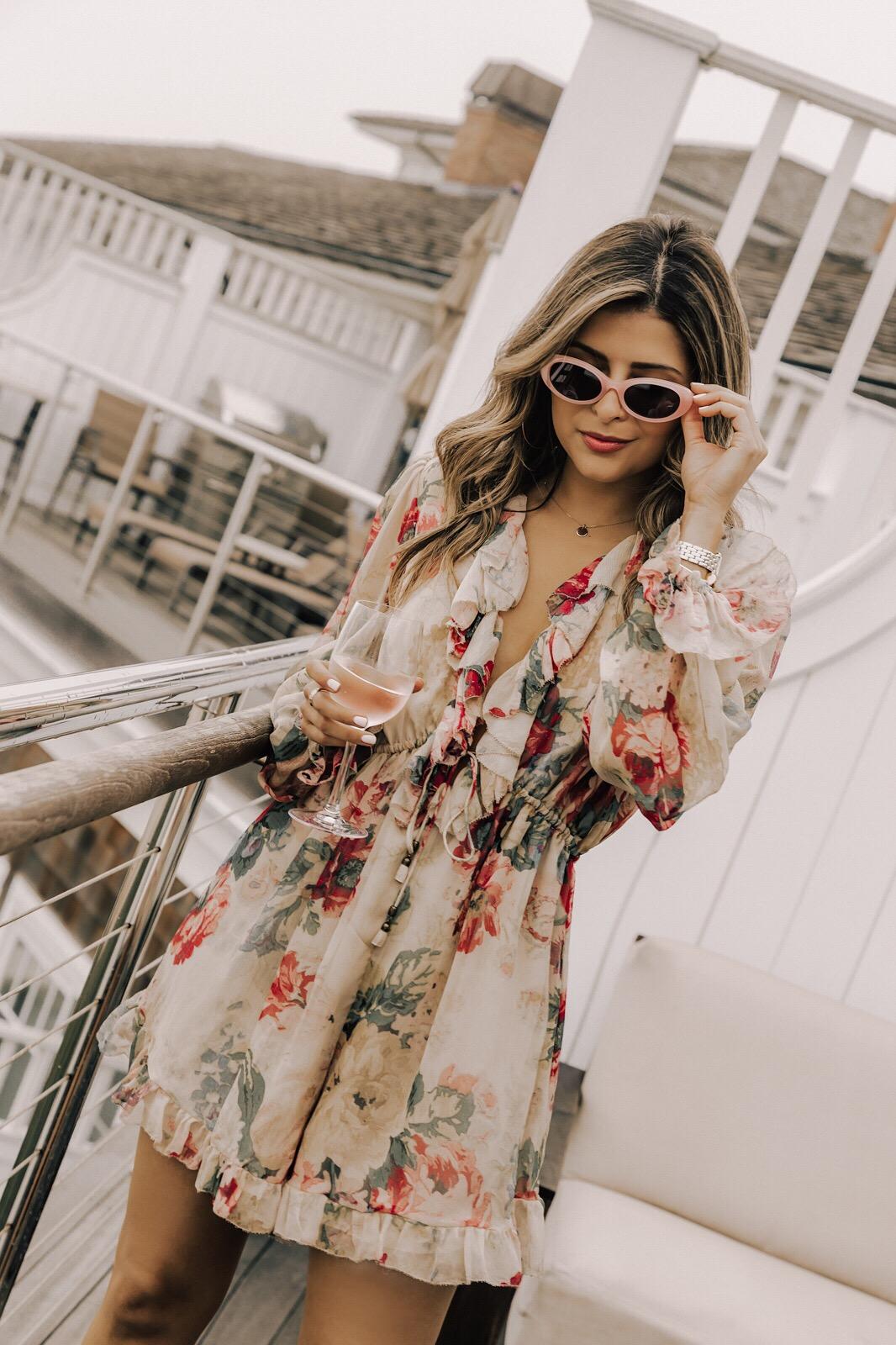 What to Wear to The Hamptons by Pam Hetlinger | Summer Fridays Hamptons Trip, Top LA Bloggers, Pam Hetlinger Style, Ruffle jumpsuit, oval sunglasses, Floral Ruffle Romper, Zimmerman Outfit, Chic Beach Look | TheGirlFromPanama.com